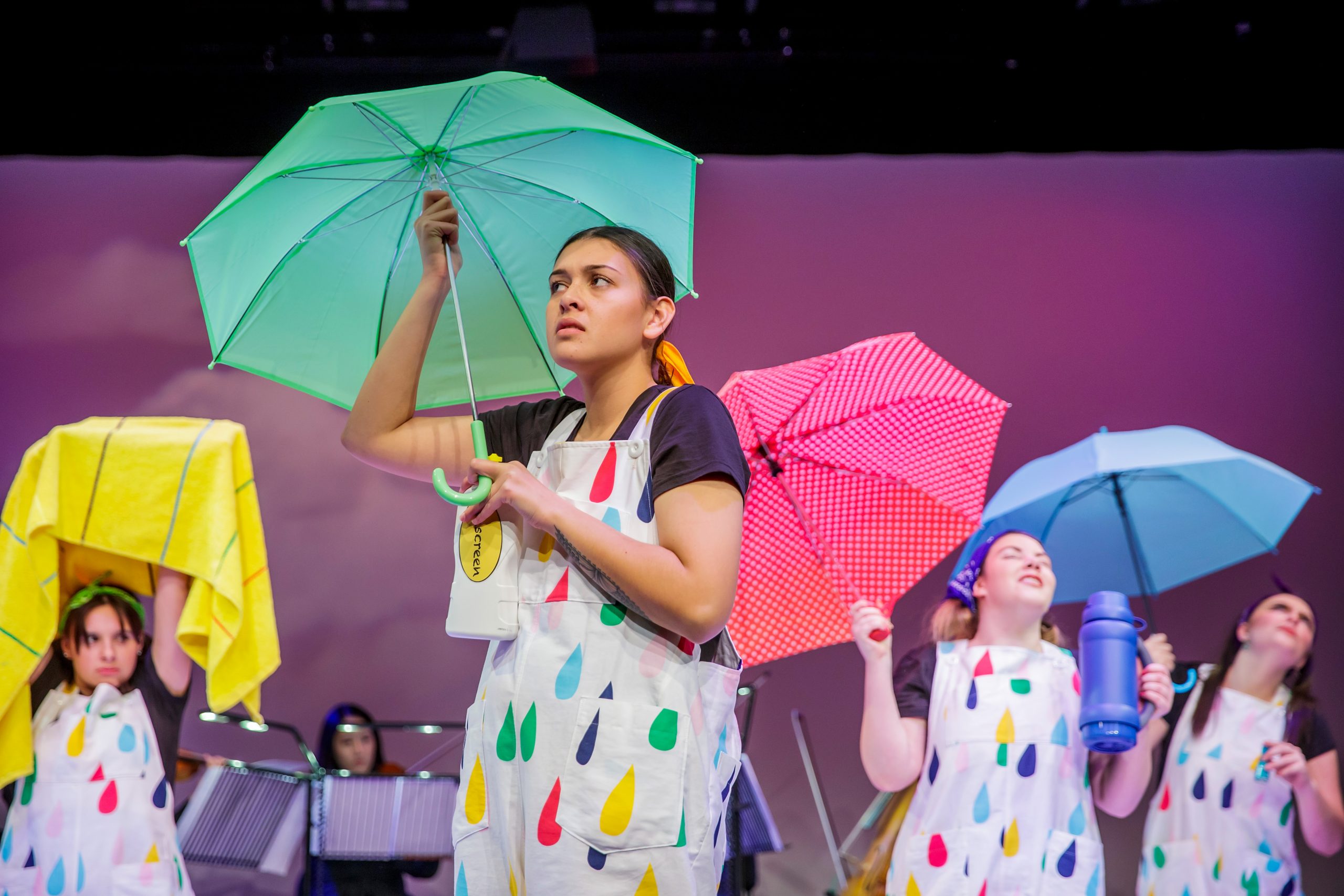 Photo of actresses of Four seasons on stage with umbrellas